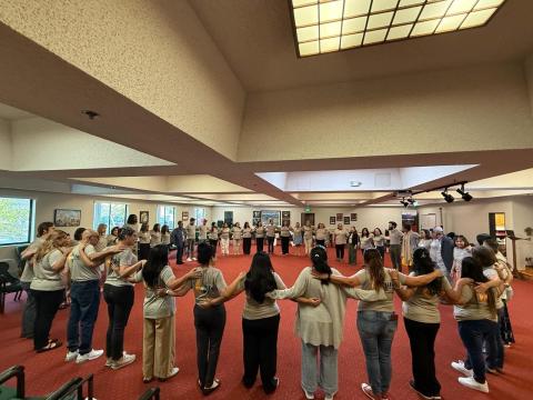 Vivid Life Home Care Cooperatives Worker-Owners in a circle during their graduation.