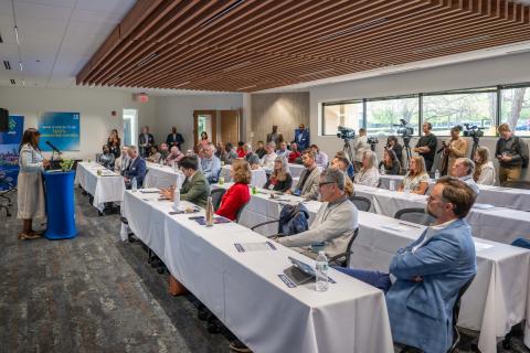 Grop of people standing listening to Dr. Darlene Deberry of UNC-Chapel Hill’s NCGrowth