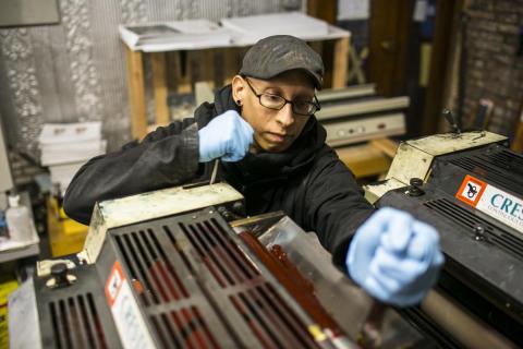 Worker operating a machine